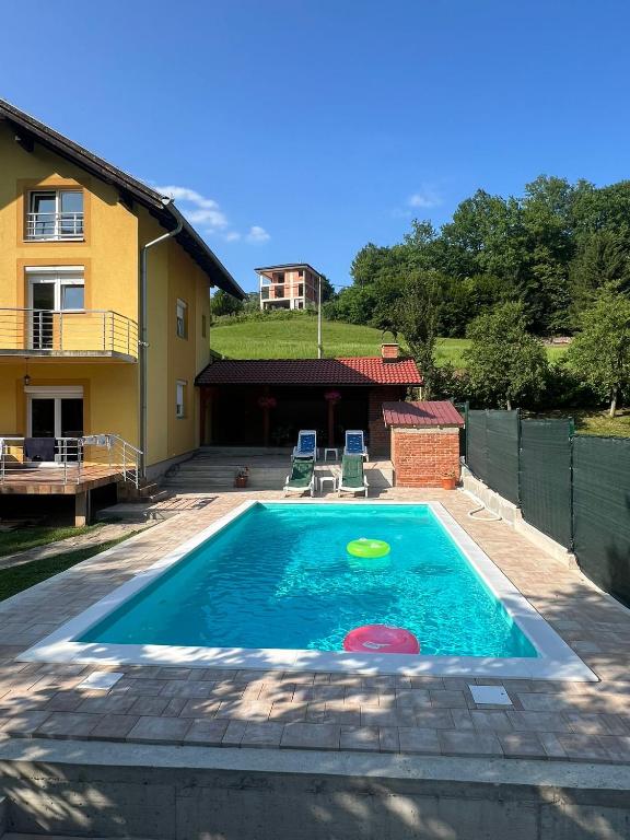 a swimming pool with a frisbee in the water at Holiday Homer Vila na Obali Vrbasa in Banja Luka