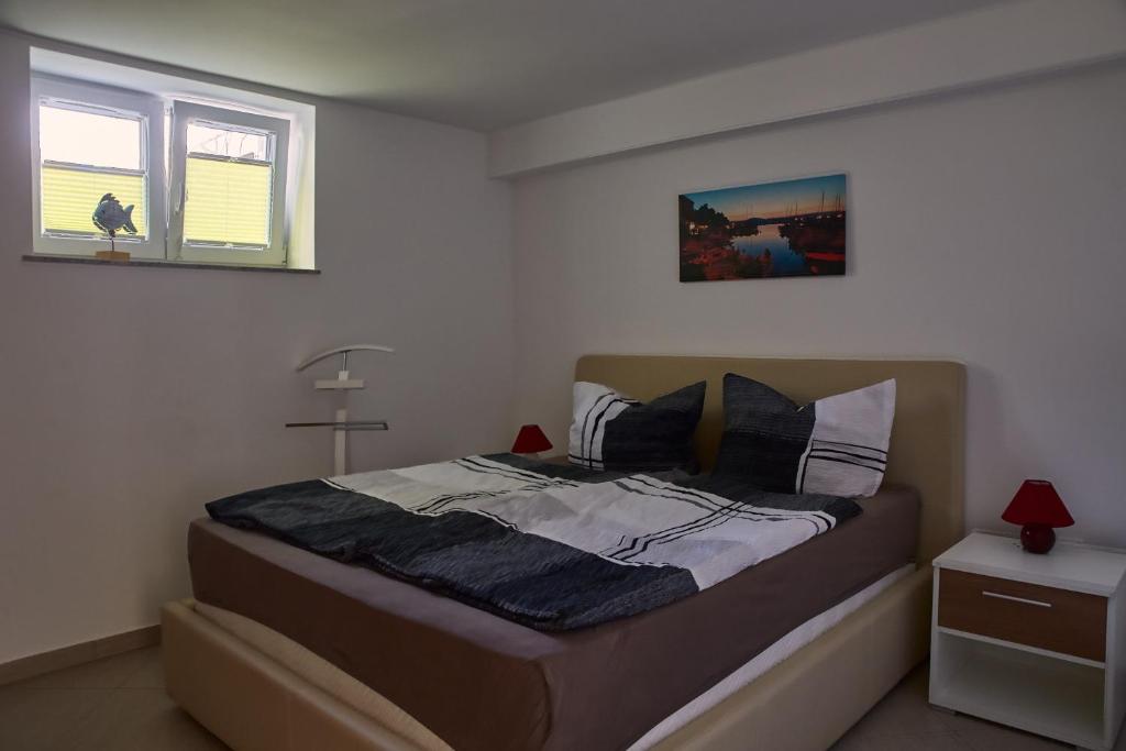 a bedroom with a bed and a window at Bruno in Barušić