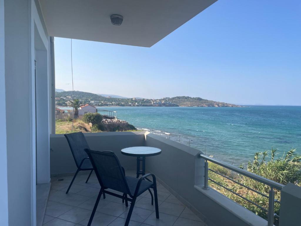 a balcony with a table and chairs and the ocean at Maria's Beach House in Karfas