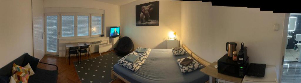 a living room with a bed and a desk at Sibejdo 3&4 in Varaždin