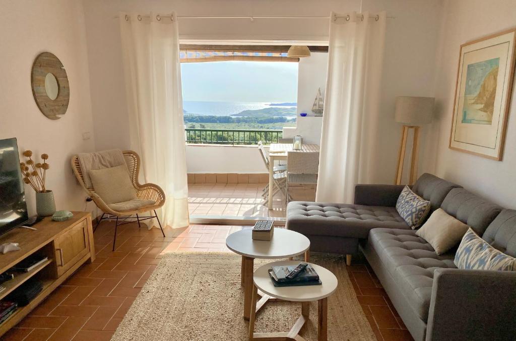 a living room with a couch and a table at La Terraza de la Sabina in Es Mercadal