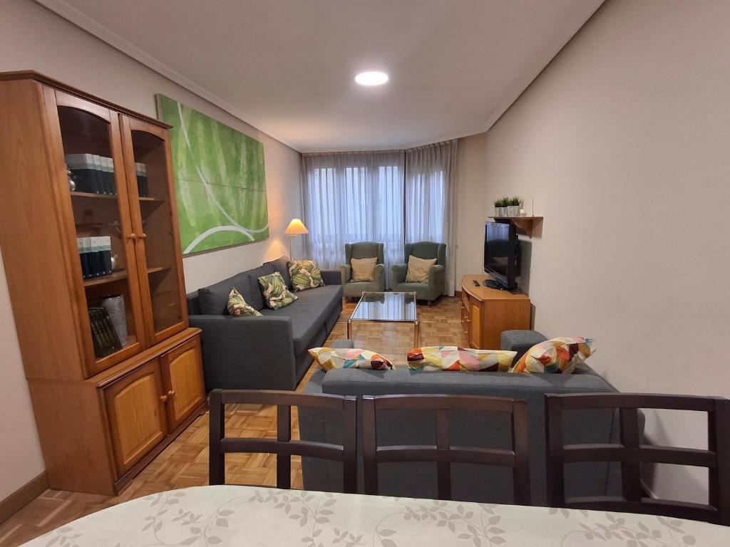 a living room with two couches and a tv at Arriondas Toyos A in Arriondas