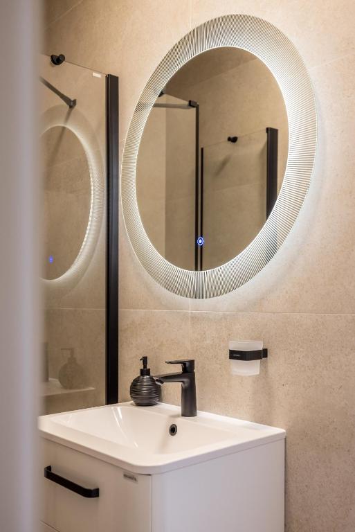 a bathroom with a white sink and a mirror at Guesthouse Rooms Split in Split