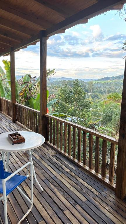 a table and chair on a deck with a view at La Casa de Bianca in El Soberbio
