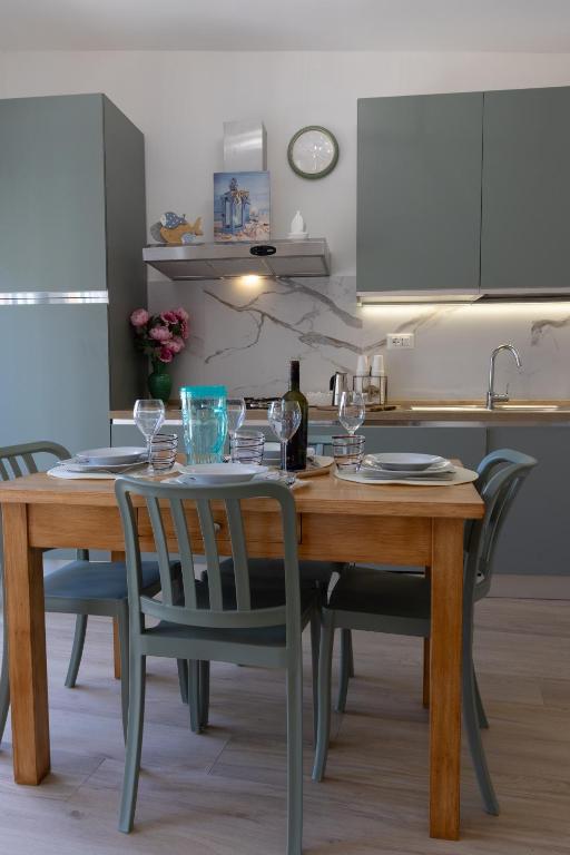 a wooden table with wine glasses on it in a kitchen at Villa MARTINA in Ortona