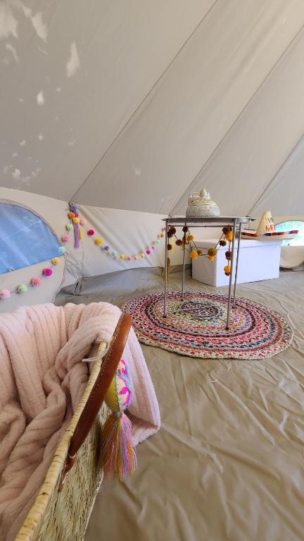 a room with a tent with a table in it at Nuit insolite tente Grandi'Ose proche Mont Saint Michel in Le Ferré