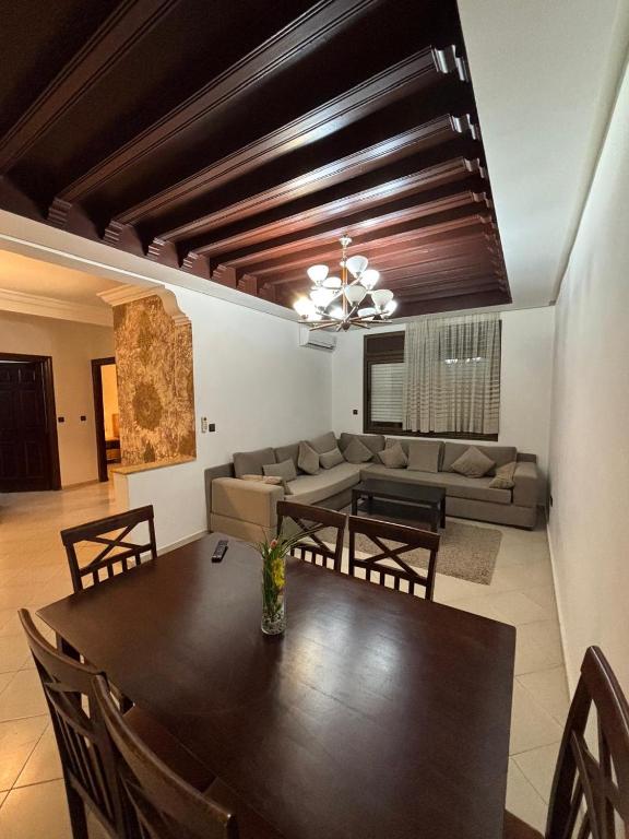 a living room with a table and a couch at Chic Studio in Agdal Walk to Everything in Rabat