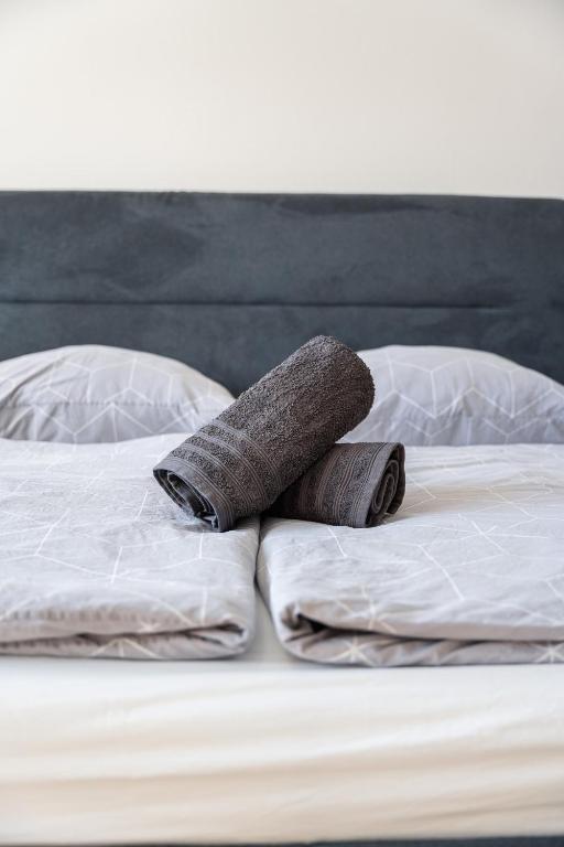 a rolled up towel sitting on top of a bed at No8 Spacious City Center Apartment in Bratislava