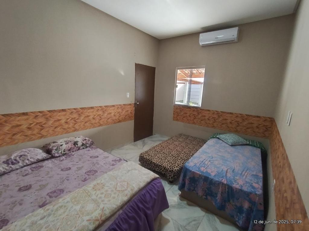 Postel nebo postele na pokoji v ubytování Espaço Acácia