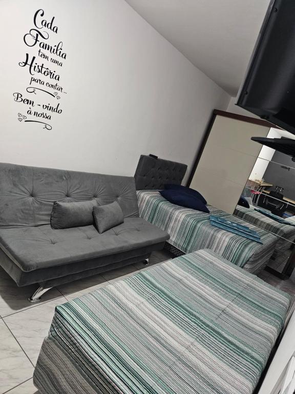 a living room with two beds and a couch at Consulado Americano apartamento 50 metros da entrada para Visto Consulado EUA Porto Alegre com garagem in Porto Alegre