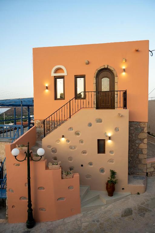 a house with a staircase in front of it at Tsolias Stone House 2 in Palekastron