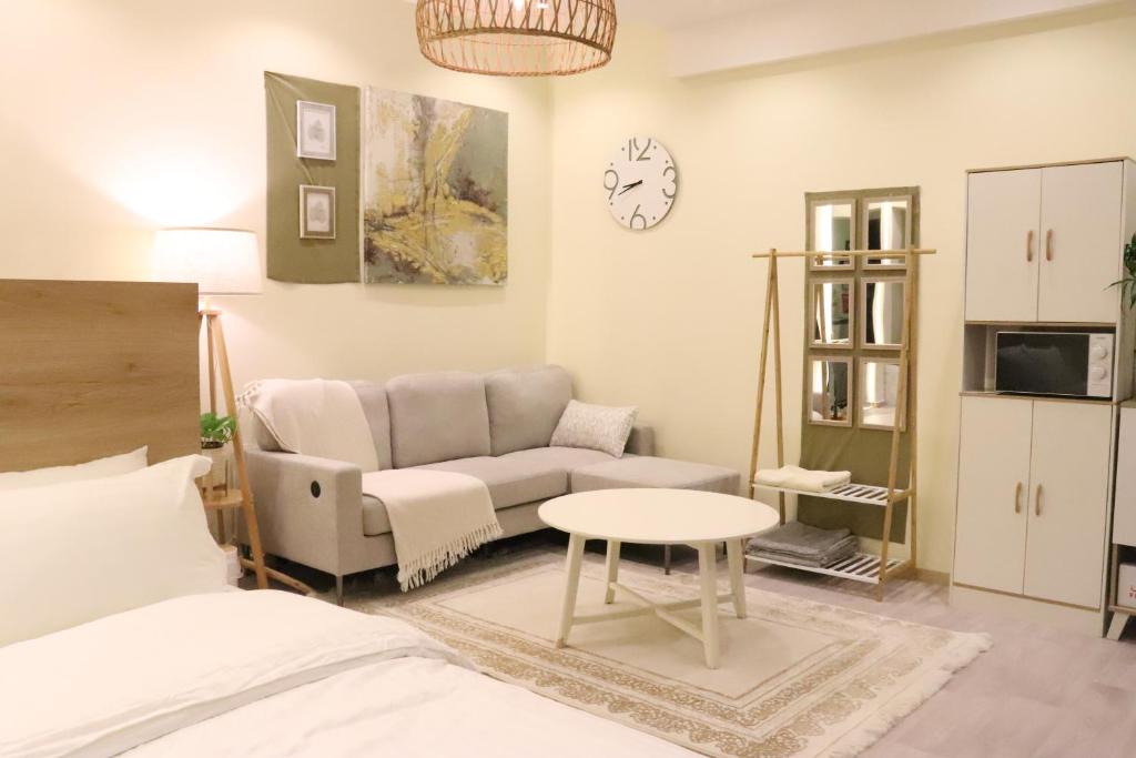 a living room with a couch and a table at Olive Residence Madinah in Medina