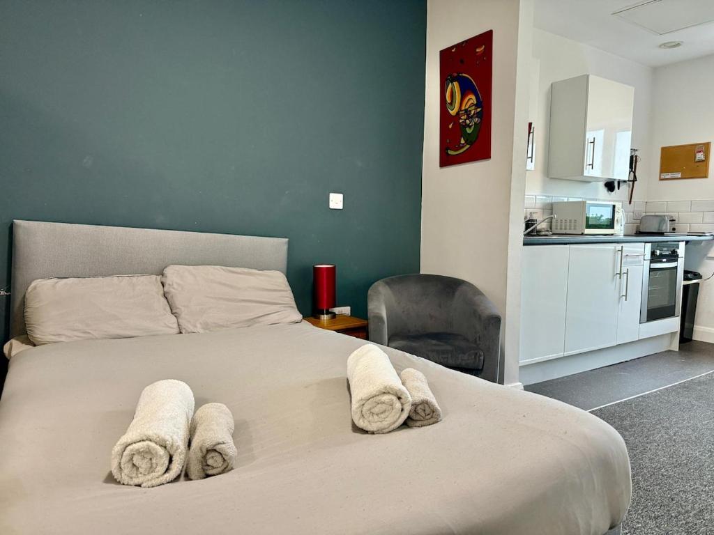 a bedroom with a bed with towels on it at Near City Liverpool Studio in Liverpool