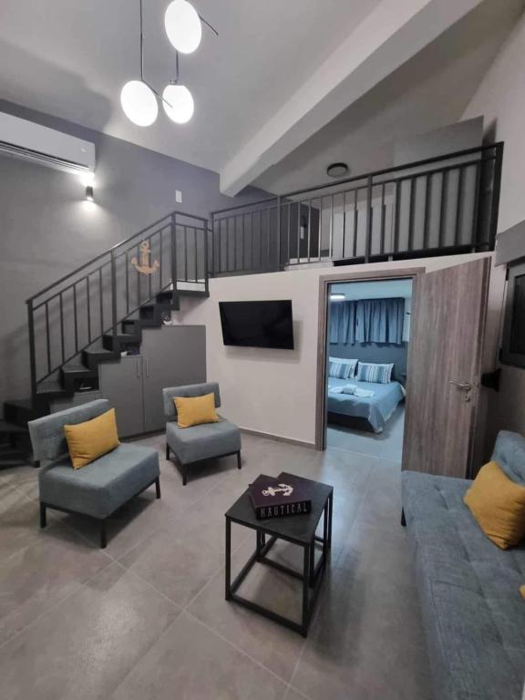 a living room with a couch and a stair case at Arianna's House in Ierapetra