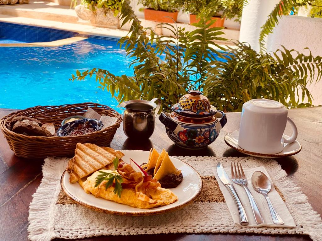a plate of food on a table next to a pool at Hotel Para Ti - Adults Only in Holbox Island
