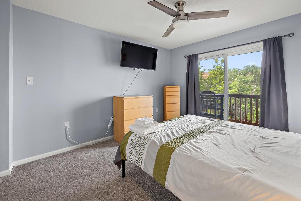 a bedroom with a bed and a flat screen tv at Family Friendly 2BR Condo with Large Balcony, Partial Ocean Views in Ocean City