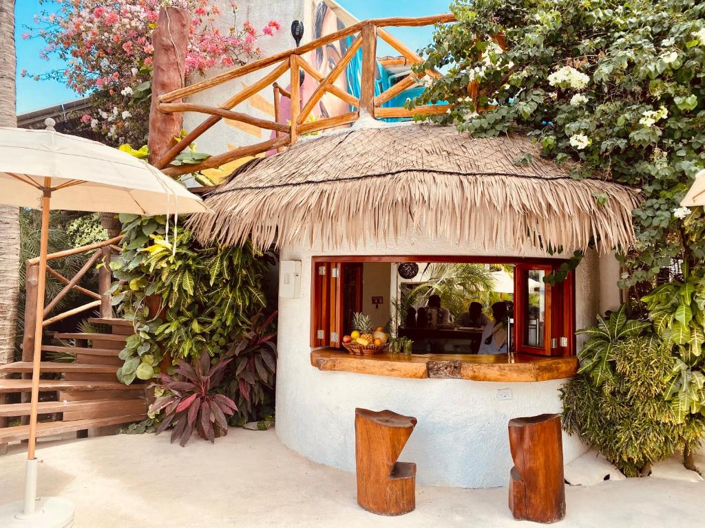a small house with a thatched roof and a restaurant at Hotel Para Ti - Adults Only in Holbox Island