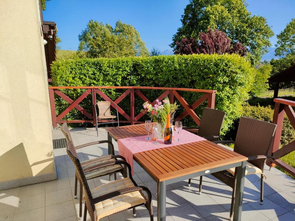 a wooden table and chairs on a patio at Eternity Chalet Trnovec in Liptovský Trnovec