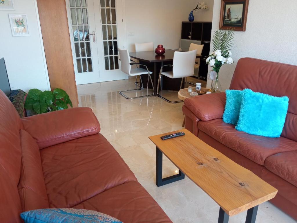 a living room with two couches and a table at ELIO Murcia El Carmen in Murcia