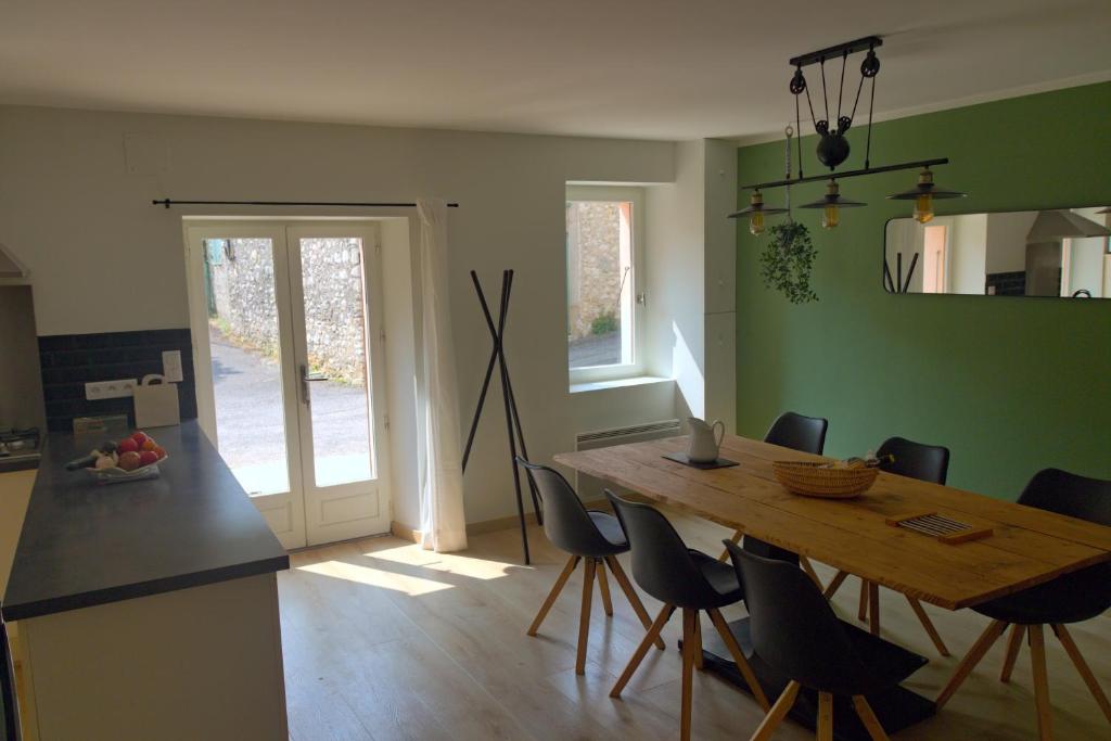 a dining room with a wooden table and chairs at Maison de village provençale Mollans-Dru in Mollans-sur-Ouvèze