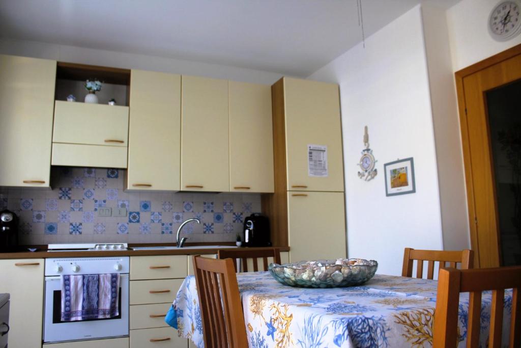 a kitchen with a table with a bowl on it at Summer House in Buonfornello