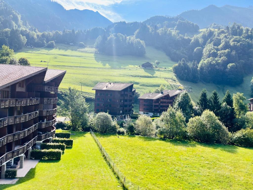 an aerial view of a resort with mountains in the background at Aparthotel Mountain River Resort in Val-d'Illiez