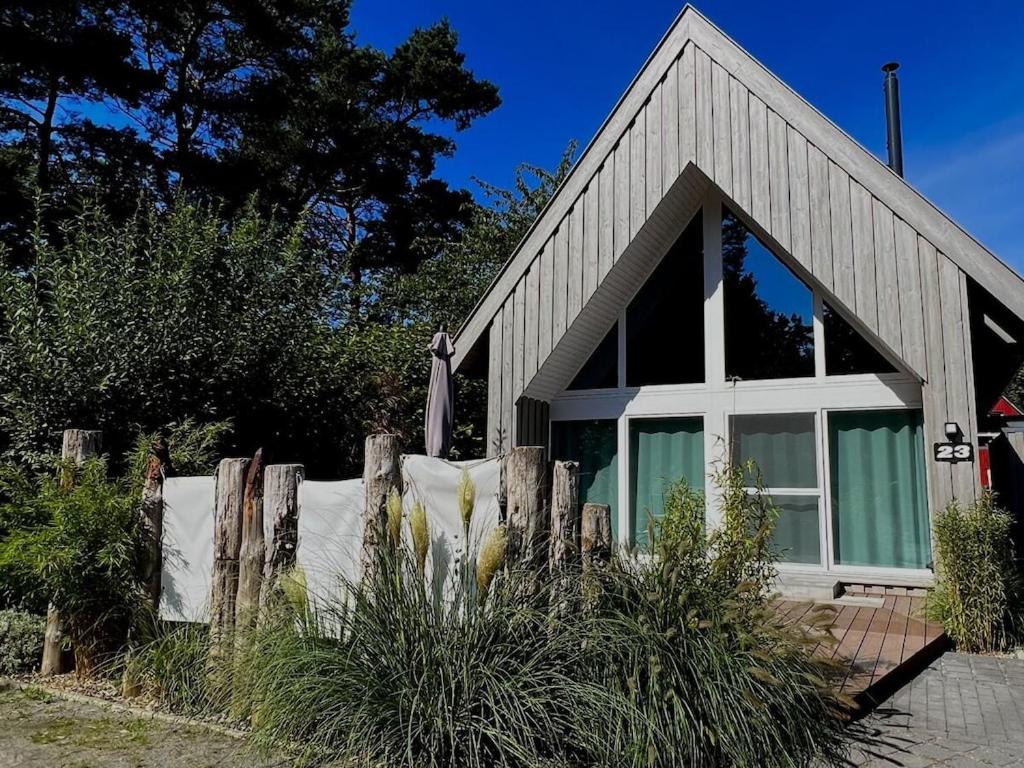 a house with a fence in front of it at Holiday home in Zingst with swimming pool in Zingst