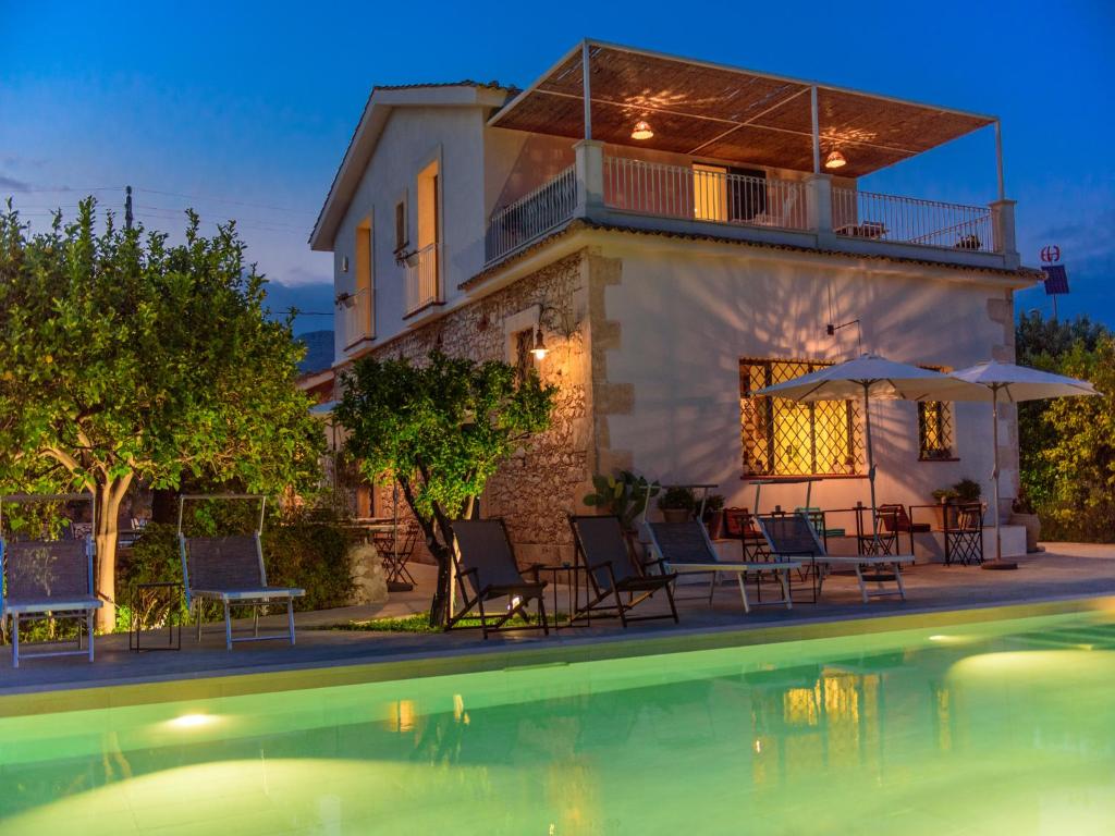 a villa with a swimming pool at night at Tenuta Don Paolino in Avola