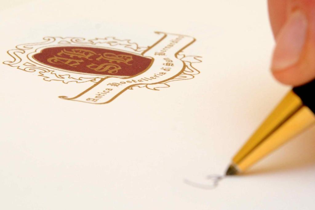 a person cutting out a drawing with a pencil at Albergo Dimora Storica Antica Hostelleria in Crema