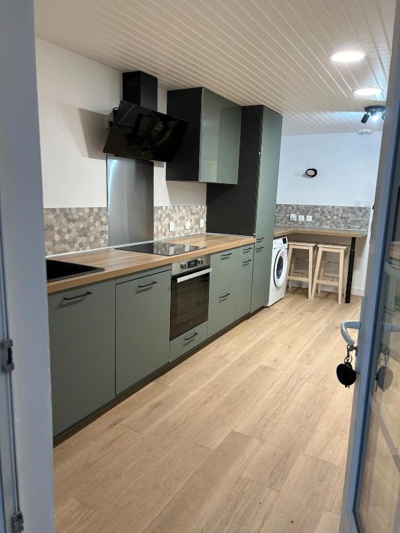a kitchen with a sink and a stove top oven at Charmante maison rénovée in Saint-Ciers-sur-Gironde