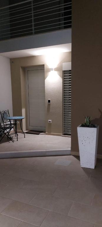 a room with a table and a bench and a light at Casa PERLAMARE in Otranto