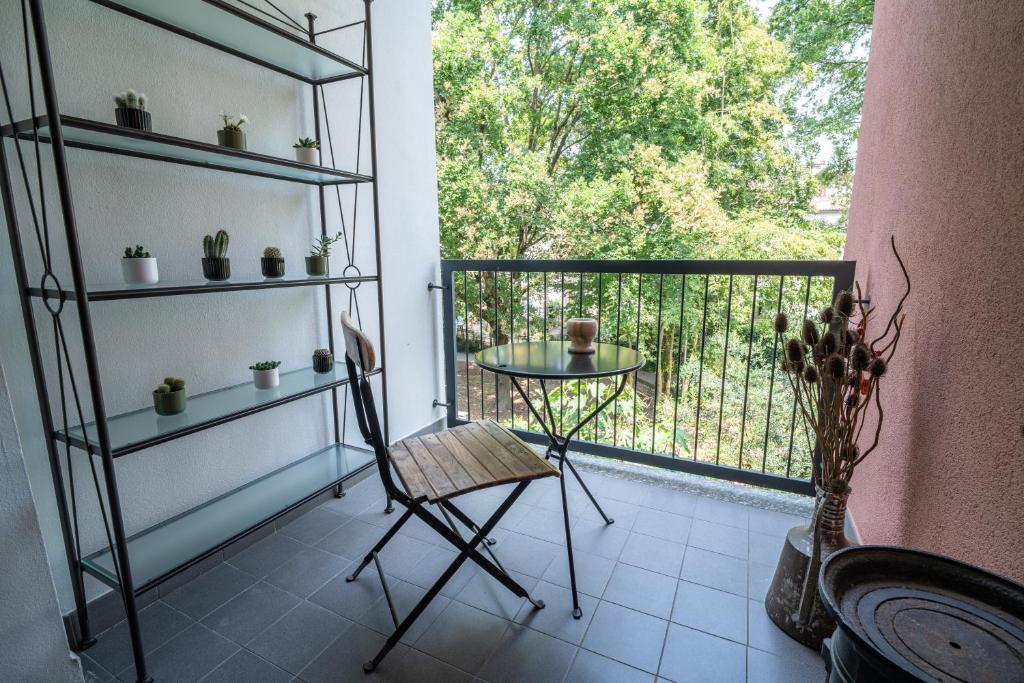 a room with a balcony with a table and a window at Aromatika, b&b, affittacamere in Faenza