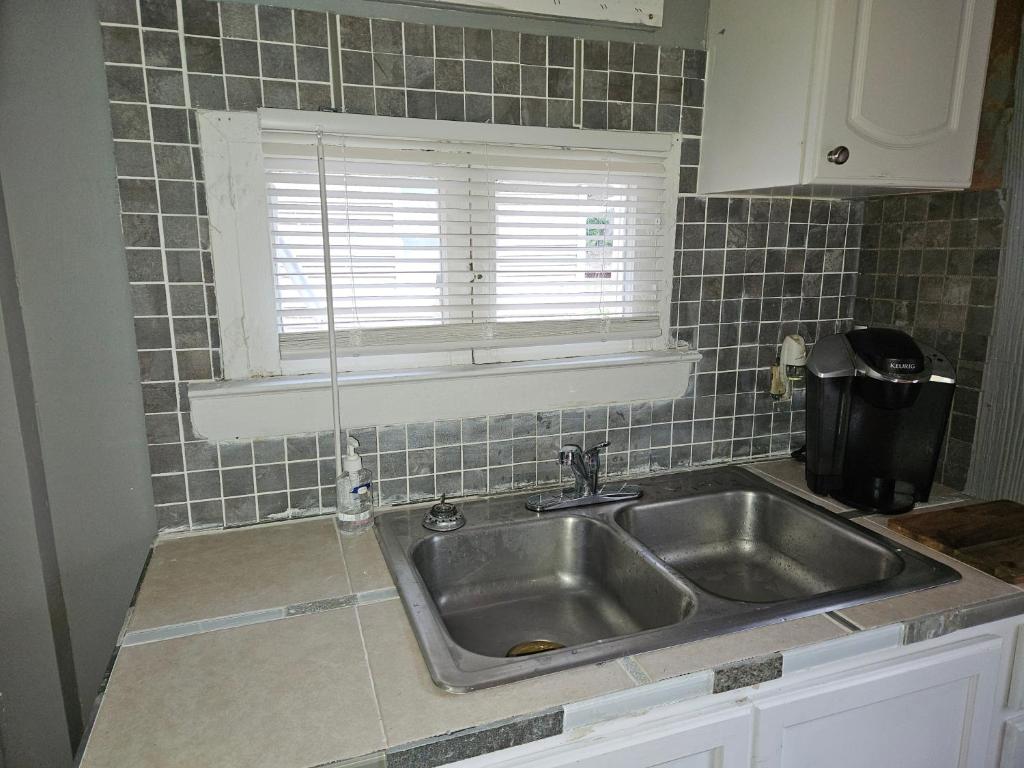 a kitchen with a sink and a window in it at The Honey Bear Cabins in Lincoln Junction