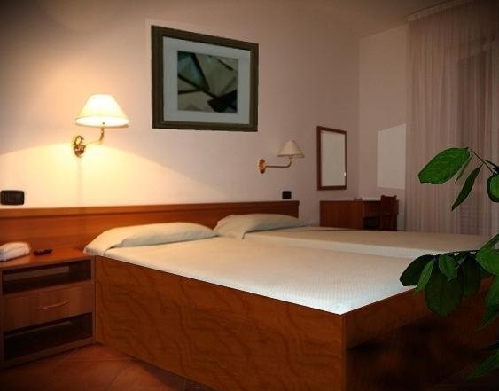 a bedroom with a large bed in a room at Hotel Ristorante La Bettola in Sasso Marconi