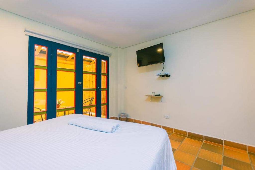 Postel nebo postele na pokoji v ubytování Hotel Bambu Guatape