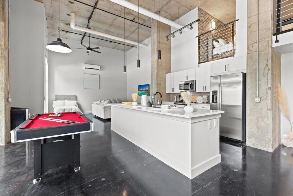 a kitchen with white cabinets and a red counter top at Luxury Loft-Coastal Vibe in Dallas