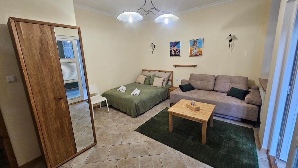 a living room with a couch and a table at Baltic Swans - Studio in Sopot