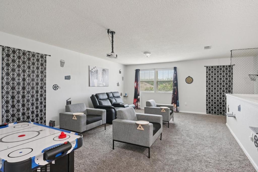 un salon avec un canapé, des fauteuils et une table dans l'établissement Lakefront Luxury Retreat 5BR, à Jacksonville