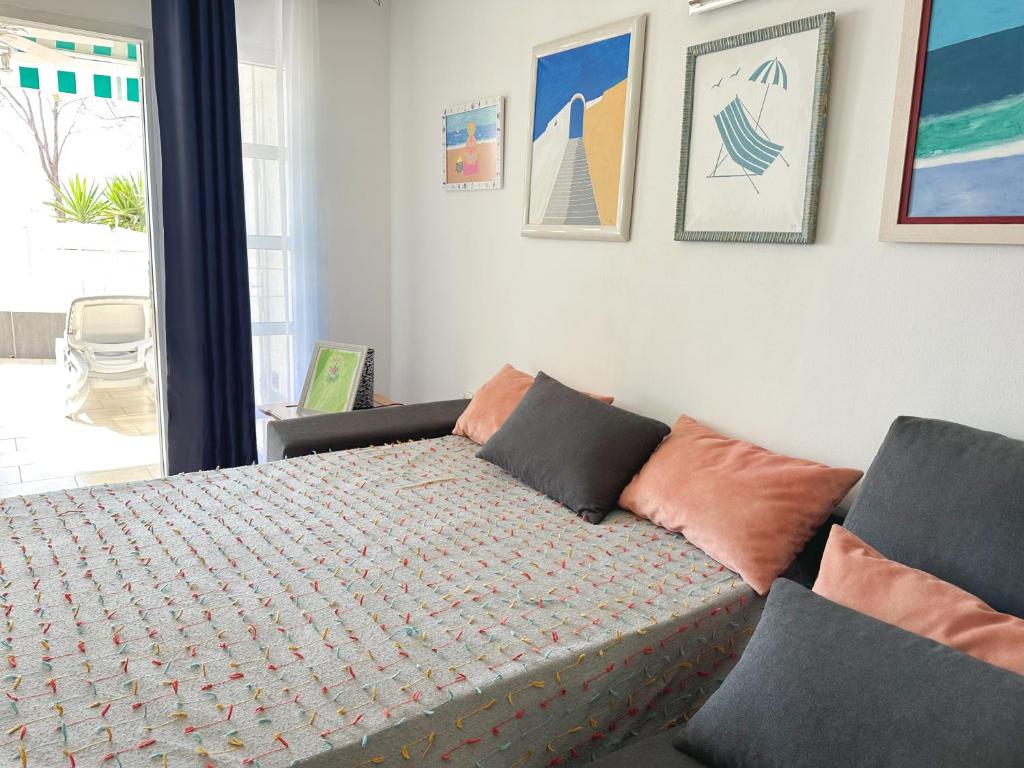 a bedroom with a bed with pillows on it at Relaxing Ocean View, Spacious Art Apartment With Large Terrace, Near Best Costa Adeje Beaches in Adeje