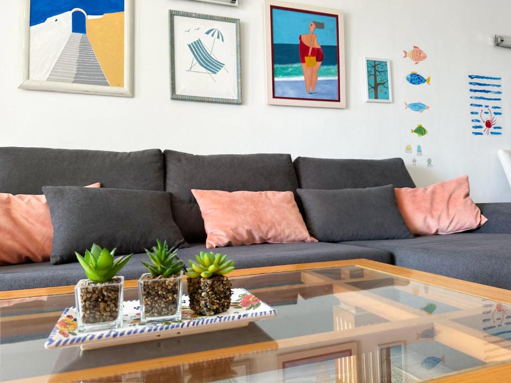 a living room with a couch and a glass table at Relaxing Ocean View, Spacious Art Apartment With Large Terrace, Near Best Costa Adeje Beaches in Adeje