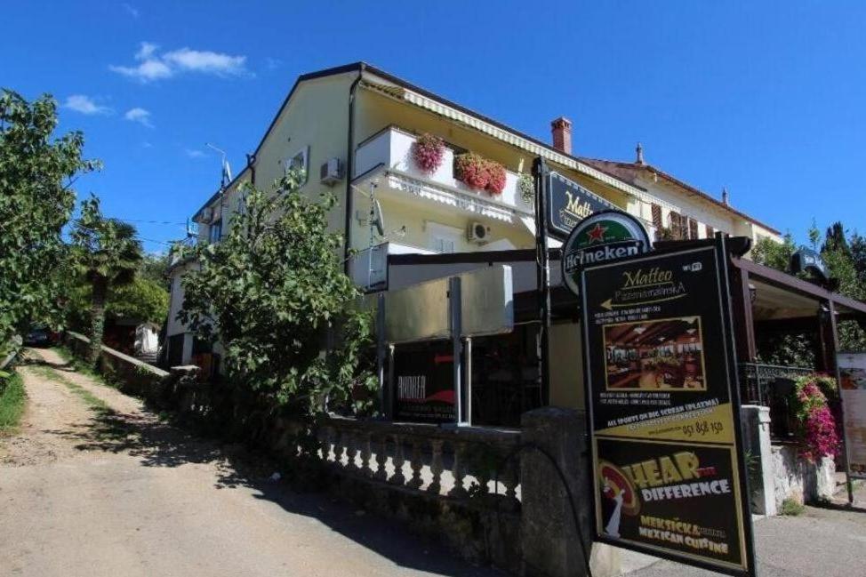 a building with a sign in front of it at Apartments by the sea nska, Krk - 24705 in Malinska
