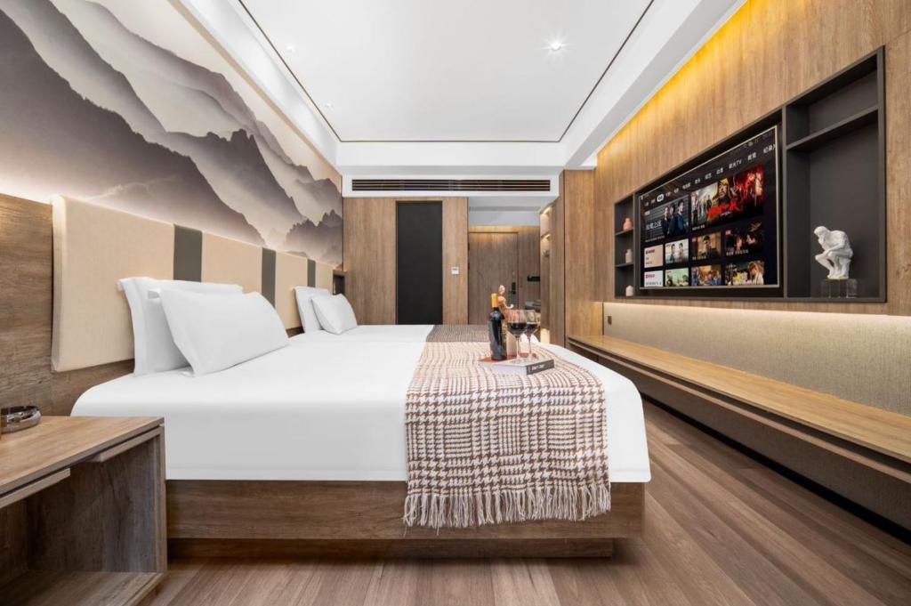 Voodi või voodid majutusasutuse Wenzhou Wuma Street Wenyuan Hotel is located in the heart of the city, easy to travel, free WiFi, breakfast, coffee, afternoon tea, free laundry service, recommended tourist attractions toas