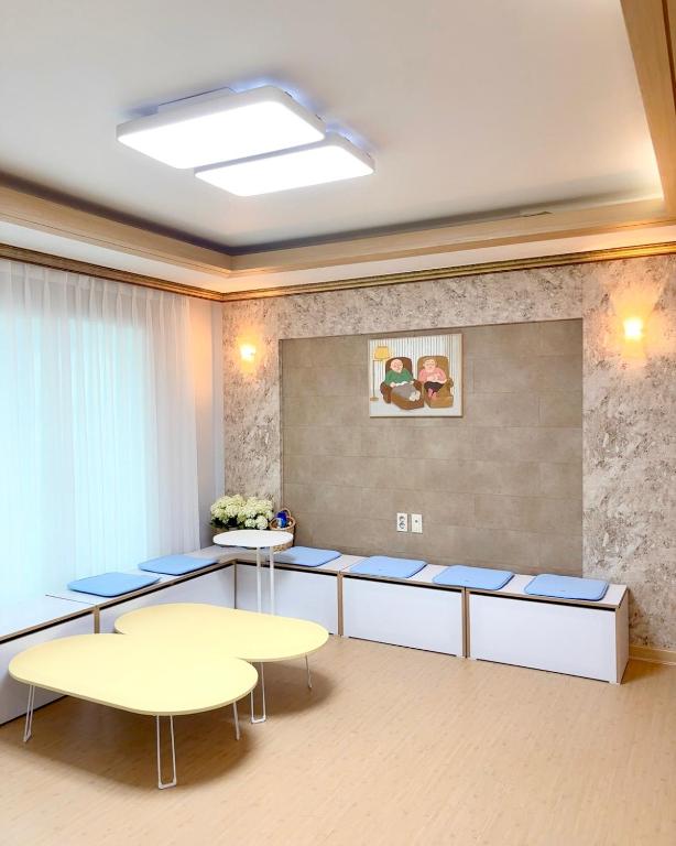 a conference room with tables and blue chairs at Daegu Gyeongsan Stay in Gyeongsan