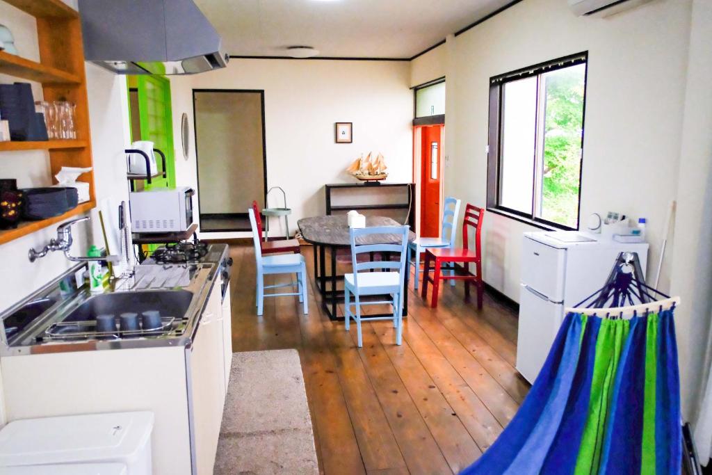 a kitchen and dining room with a table and chairs at しまなみ宿Ebi in Imabari
