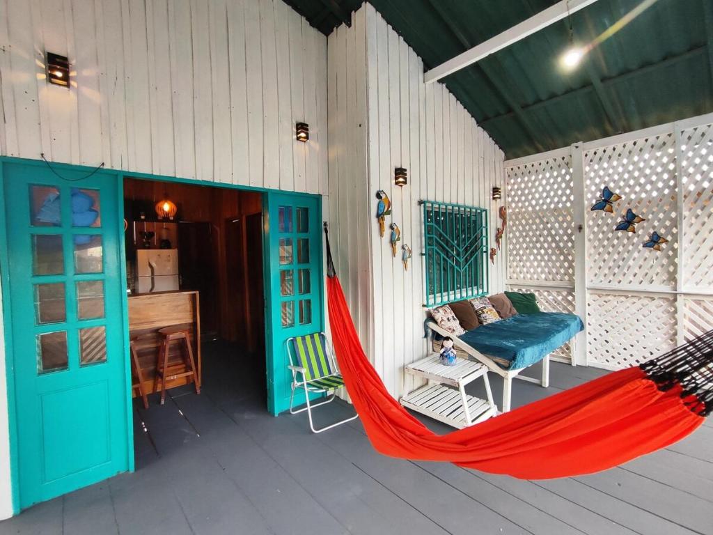 a hammock on a porch of a house at Casa de Praia Dunnas - Ajuruteua - Pa in Bragança