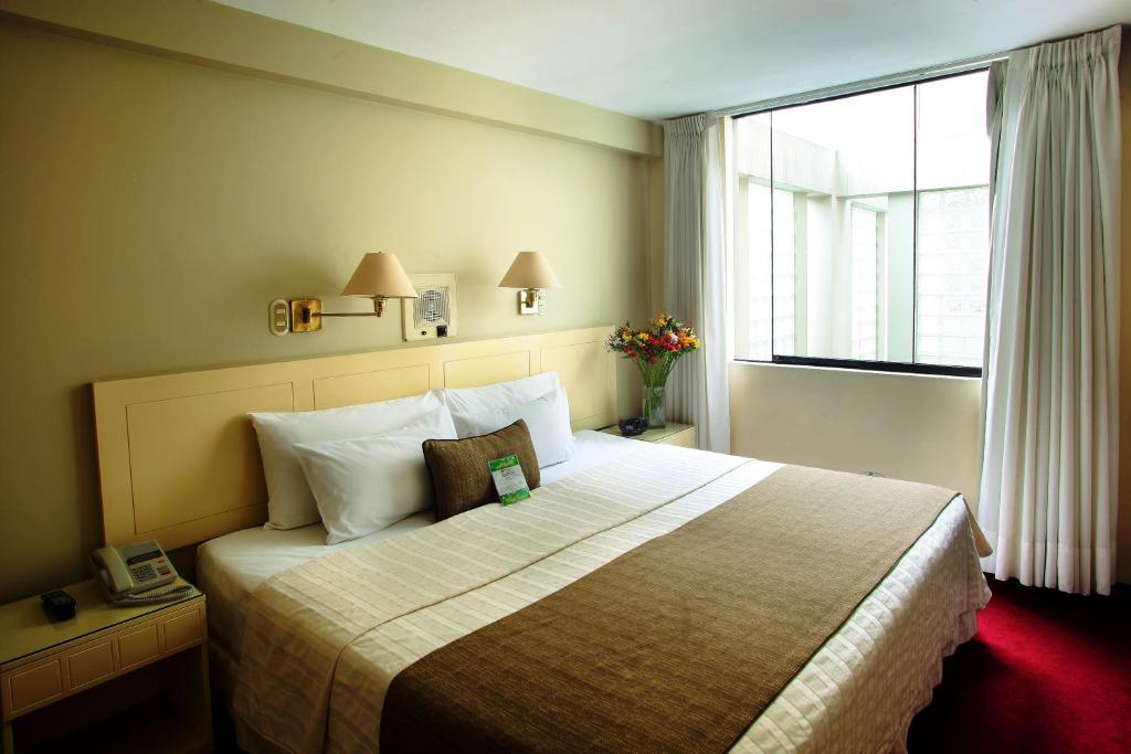 Кровать или кровати в номере Embajadores Hotel