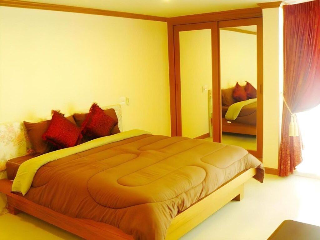 Ένα ή περισσότερα κρεβάτια σε δωμάτιο στο Rouge Service Apartments, Soi Buakhao