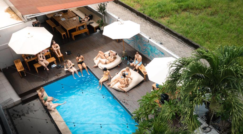 a group of people in a swimming pool at Surf & Party - Hostel Somewhere Else in Canggu