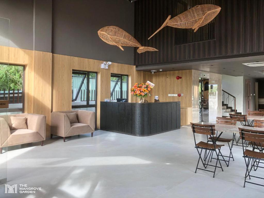 eine Lobby mit Stühlen und einer Theke mit einem Tisch in der Unterkunft THE MANGROVE GARDEN CẦN GIỜ in Ấp Long An