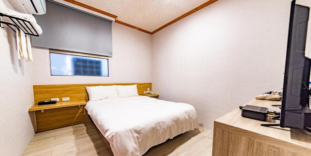 Postel nebo postele na pokoji v ubytování Beauty Garden Hotel - Jiaoxi